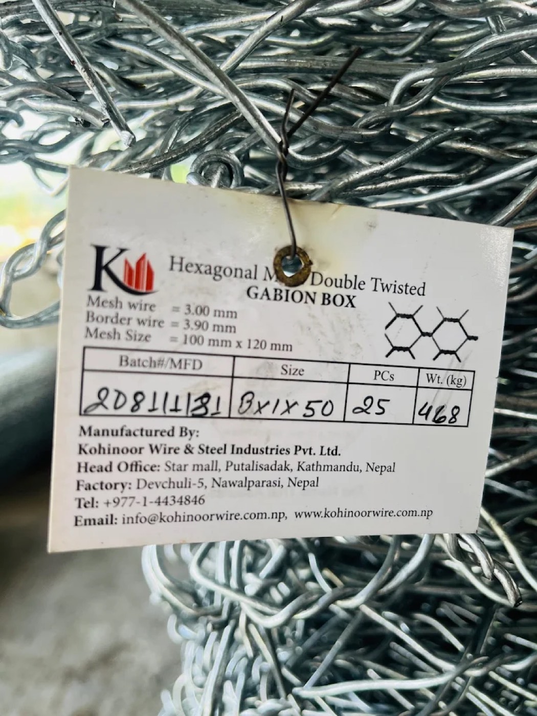 Close-up of a Kohinoor Gabion Box specification tag showing mesh size and batch number